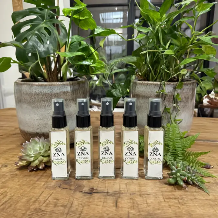 The perfume_bottles on a table with plants.webp